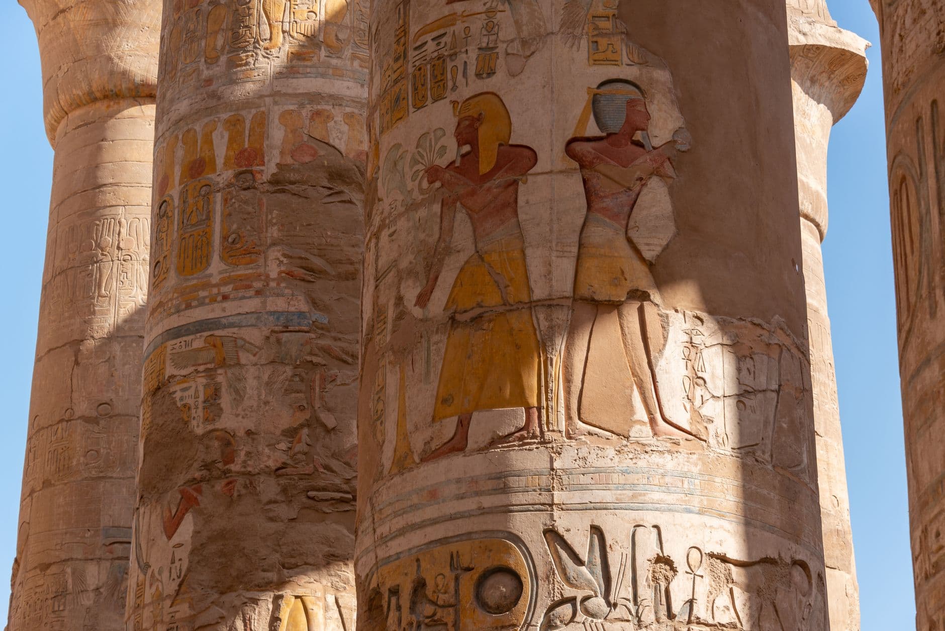 Detailed hieroglyphic reliefs on temple columns in Egypt