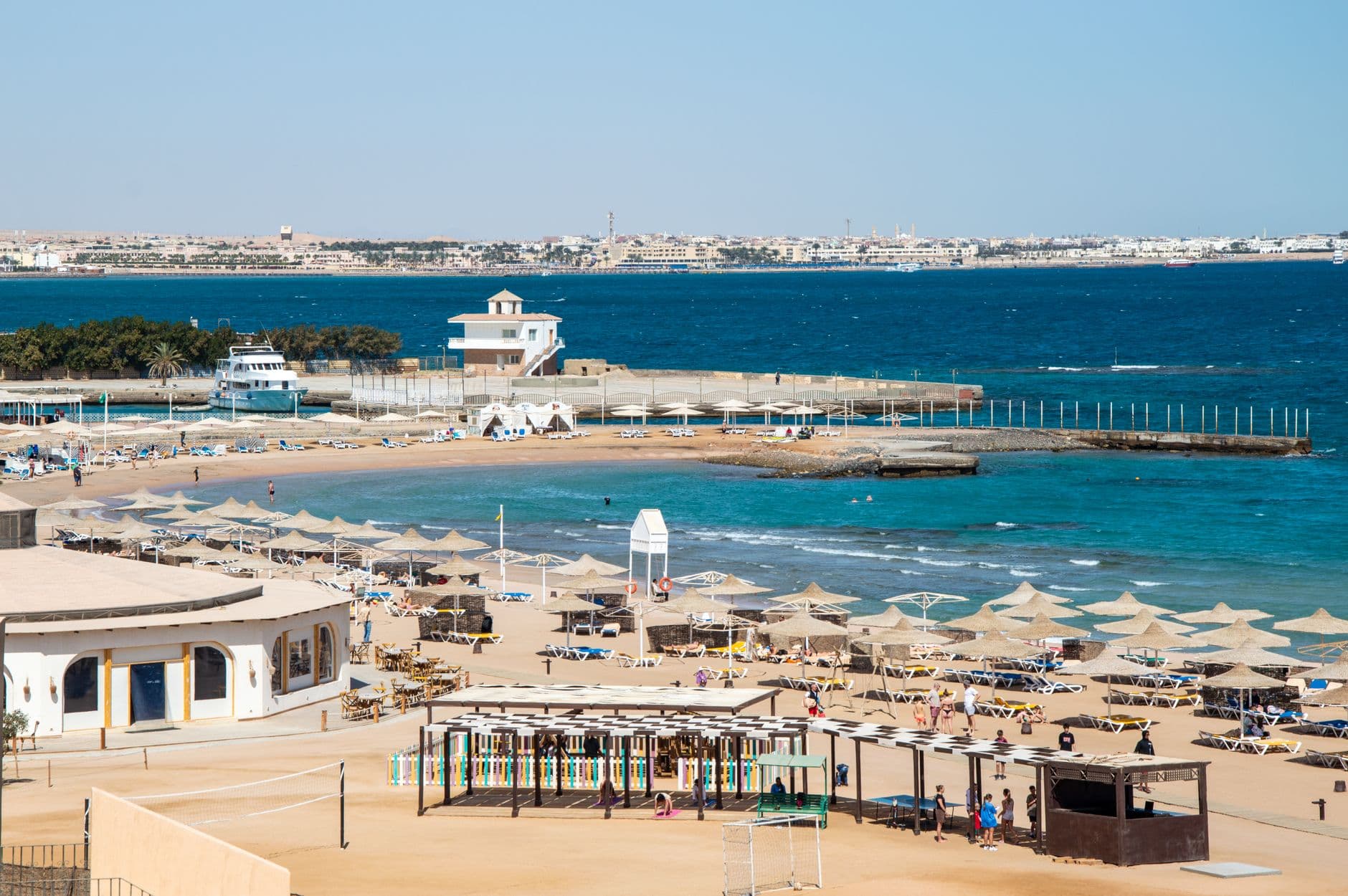 A Red Sea resort beach with sun loungers and umbrellas